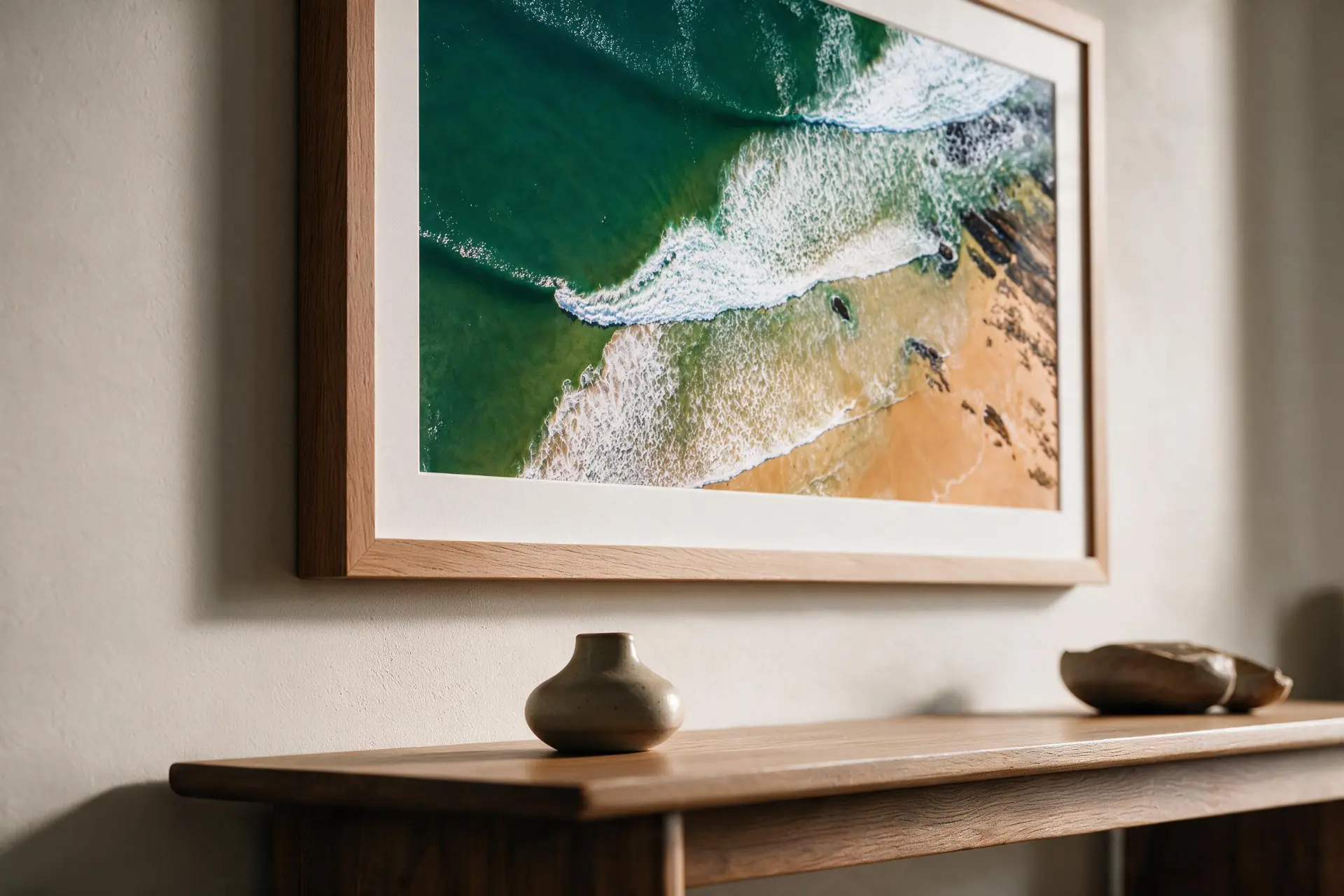 A framed Salt Atlas coastal photograph displayed in a refined interior setting